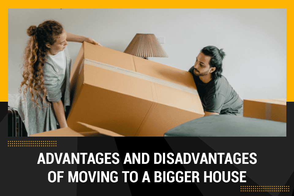 a man and a woman lifting a box while moving to a bigger house