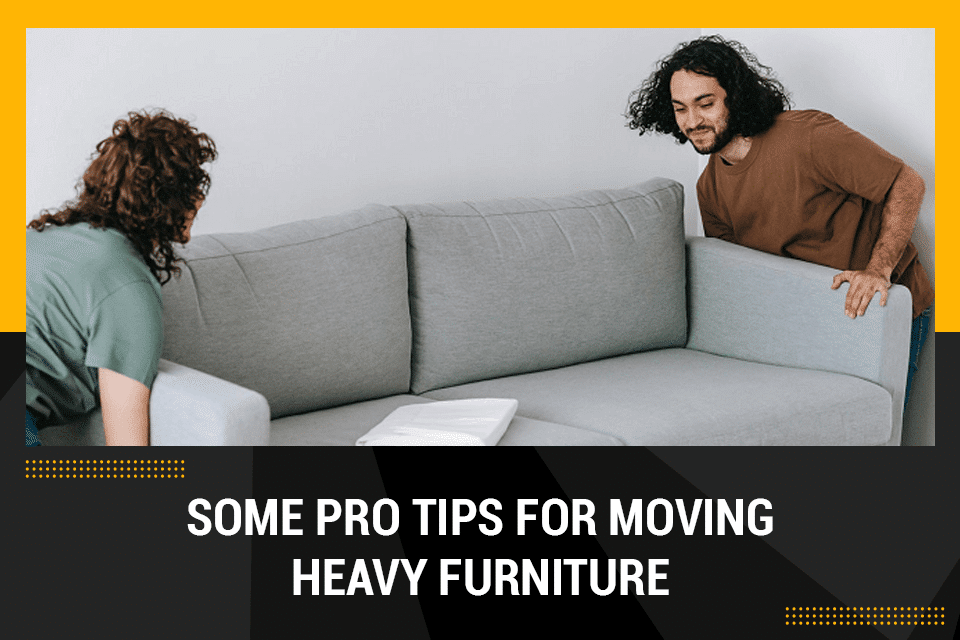 two people moving heavy furniture